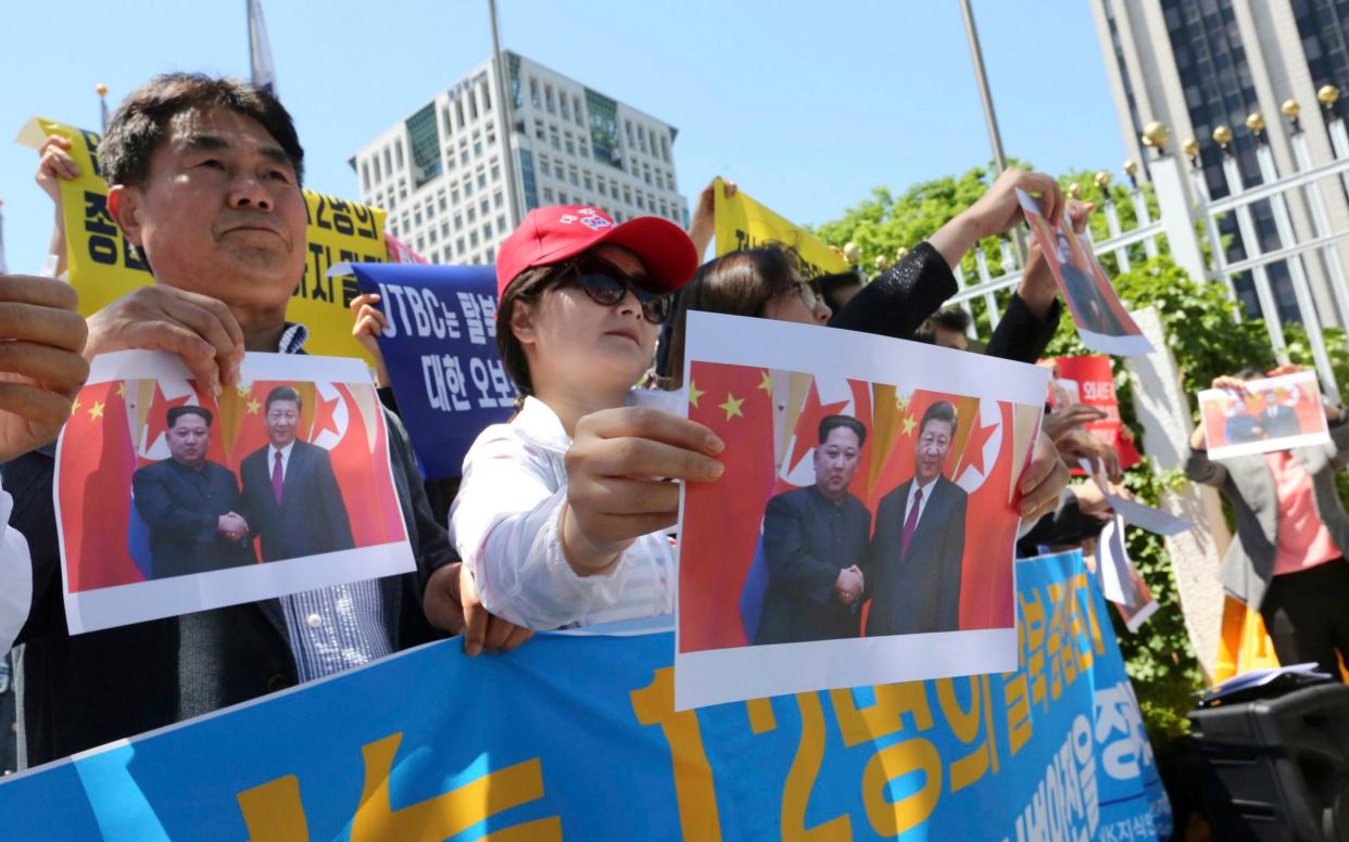 North Korean defectors demonstrate in central Seoul against the possible repatriation of restaurant workers - AP