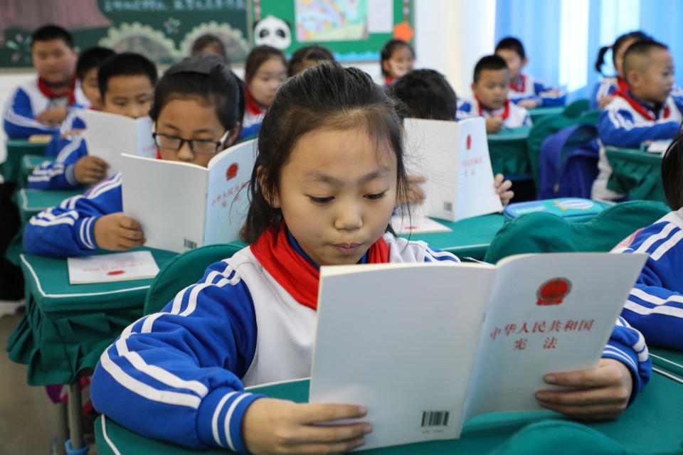 DONGYING, CHINA - DECEMBER 03: Primary school students read the Constitution of the People's Republic of China on December 3, 2019 in Dongying, Shandong Province of China. National Constitution Day of China falls on December 4 every year. (Photo by Song Xinggang/VCG via Getty Images)
