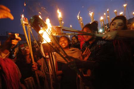 People take part in a torch-lit rally as they celebrate after the Supreme Court rejected Abdul Quader Mollah's request for an appeal against his death sentence in Dhaka December 12, 2013. REUTERS/Andrew Biraj