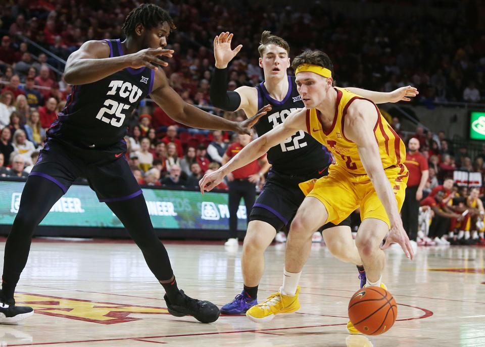 Iowa State's Caleb Grill, drives\with the ball around TCU's Souleymane Doumbia (25) and guard Tyler Lundblade (22) during the first half of a Feb. 15 game in Ames.