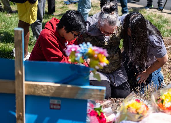 NASHVILLE, TN - MARCH 28: Mourners pray at the entrance of The Covenant School on March 28, 2023 in Nashville, Tennessee. According to reports, three students and three adults were killed by the 28-year-old shooter on Monday.  (Photo by Seth Herald/Getty Images)