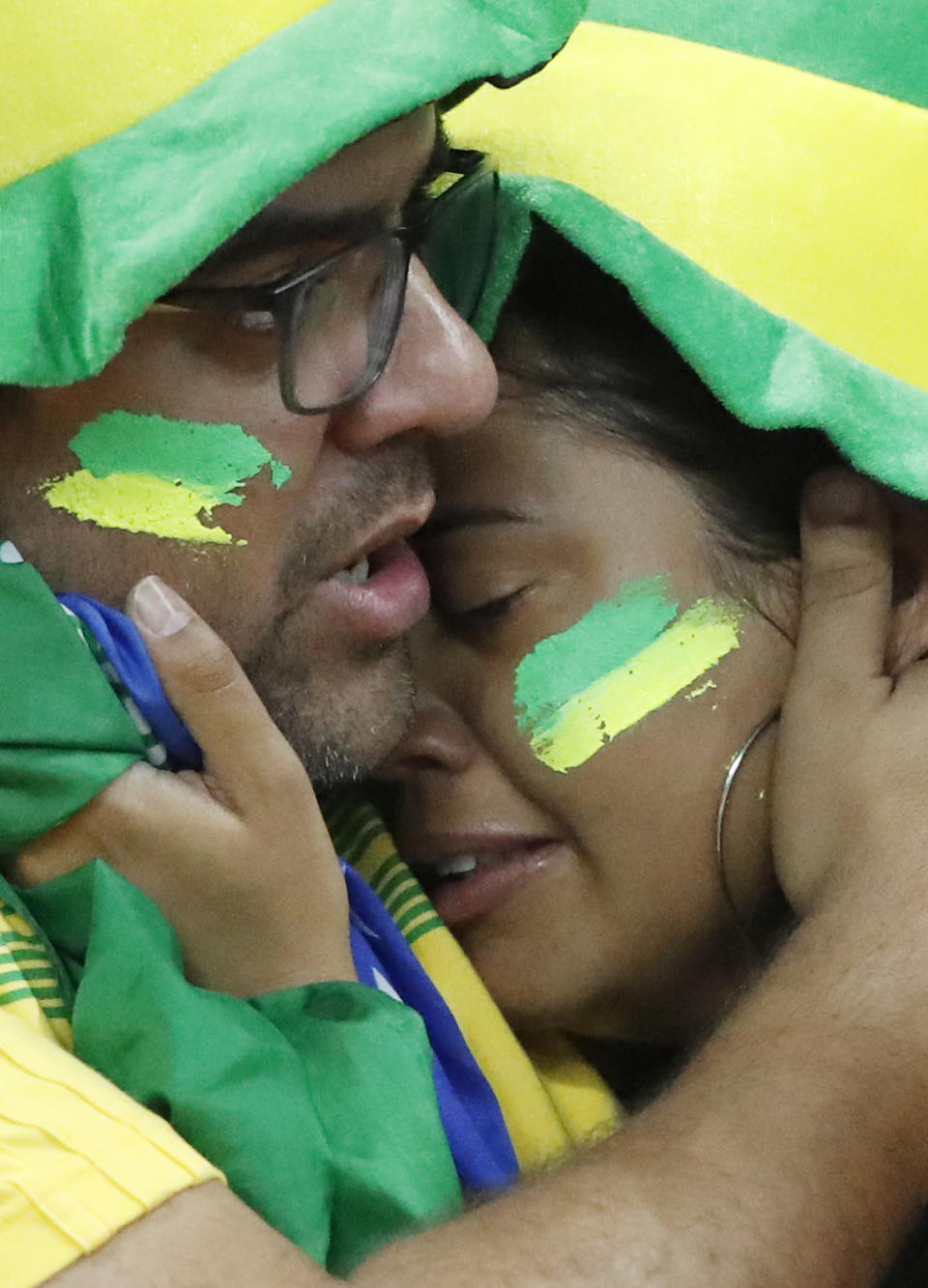 <p>Two fans react after Brazil were sent home by Belgium </p>