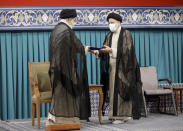 In this photo released by an official website of the office of the Iranian supreme leader, newly elected President Ebrahim Raisi, right, receives the official seal of approval from Supreme Leader Ayatollah Ali Khamenei in an endorsement ceremony in Tehran, Iran, Tuesday, Aug. 3, 2021. (Office of the Iranian Supreme Leader via AP)