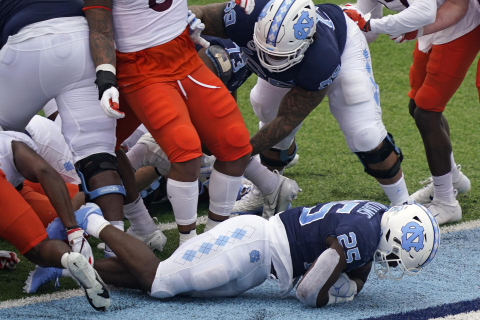 North Carolina running back Javonte Williams (25) scores a touchdown against Virginia Tech during the first half of an NCAA college football game in Chapel Hill, N.C., Saturday, Oct. 10, 2020. (AP Photo/Gerry Broome)