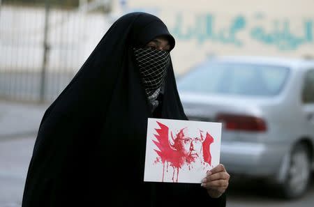 A protester holds an image depicting Saudi Shi'ite cleric Nimr al-Nimr as she protests against his execution by Saudi authorities, in village of the Sanabis, west of Manama, Bahrain January 2, 2016. REUTERS/Hamad I Mohammed