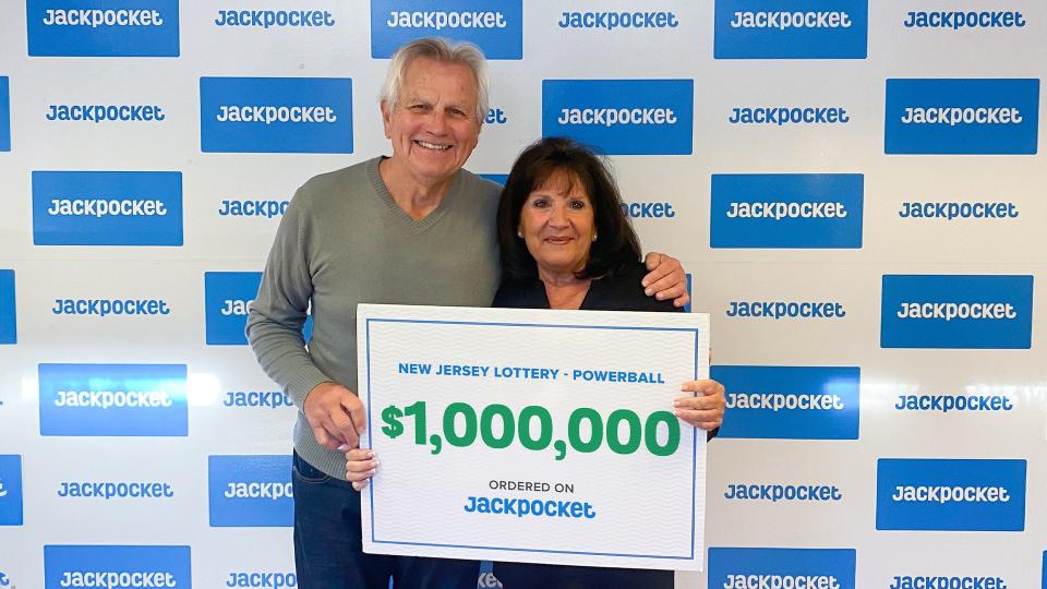 Joseph W. and his wife holding his $1 million check