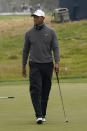 Tiger Woods walks on the putting green during practice for the PGA Championship golf tournament at TPC Harding Park in San Francisco, Tuesday, Aug. 4, 2020. (AP Photo/Jeff Chiu)