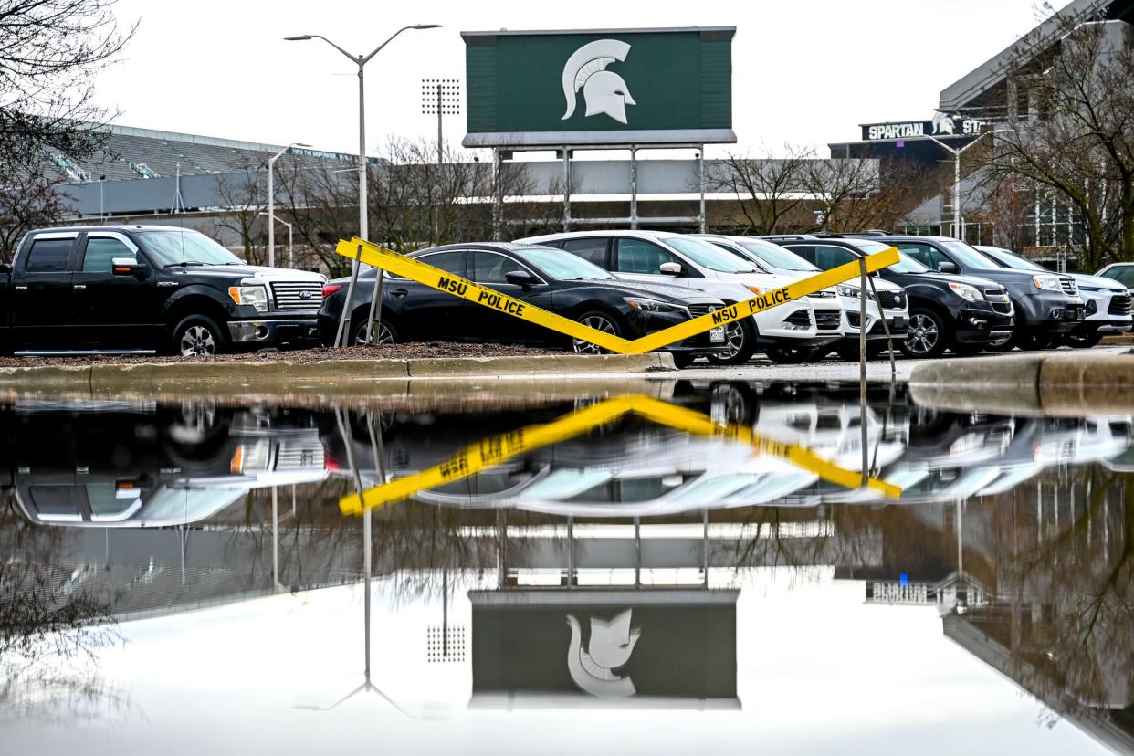 A portion of a parking lot outside Spartan Stadium is flooded after a storm on Wednesday, April 5, 2023, on the Michigan State campus in East Lansing.