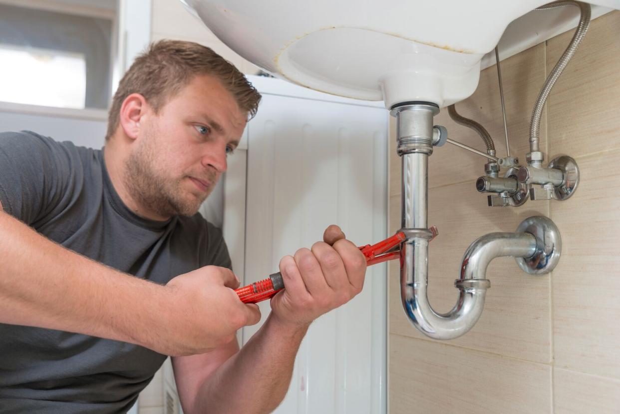 plumber working on sink