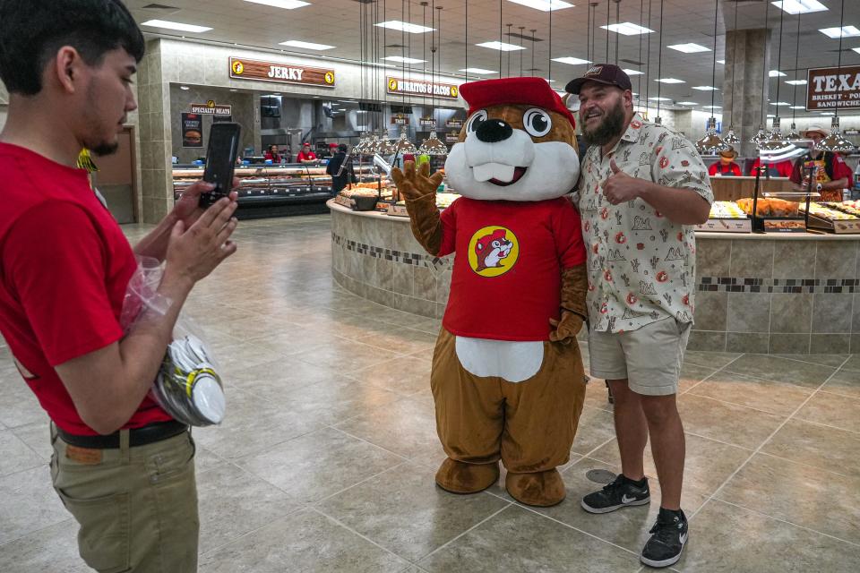 Scott Rinkel, right, takes a photo with Bucky the Beaver on opening day at the new largest Buc-ee’s travel center in Luling, Texas on Monday, June 10, 2024.