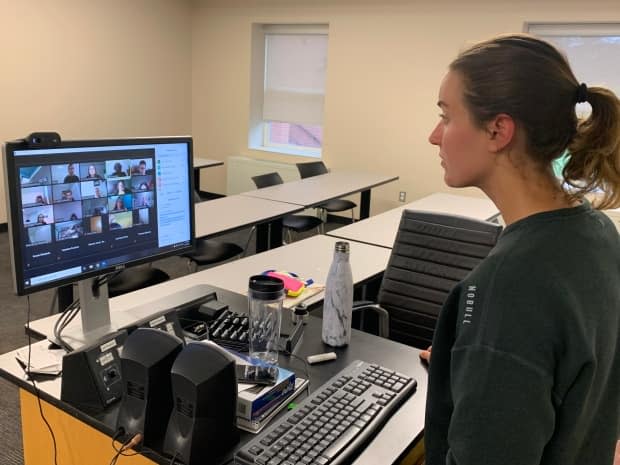 A teacher at an English as a second language school works with students on line via Zoom, from a classroom on campus at UPEI.  (Laura Meader/CBC - image credit)