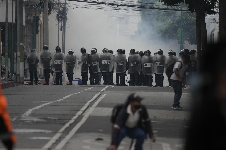 Riot police form a cordon during a protest by veterans demanding that a law be passed that compensates them for having served during the country's civil war, outside the Congress building in Guatemala City, Tuesday, Oct. 19, 2021. (AP Photo/Moises Castillo)