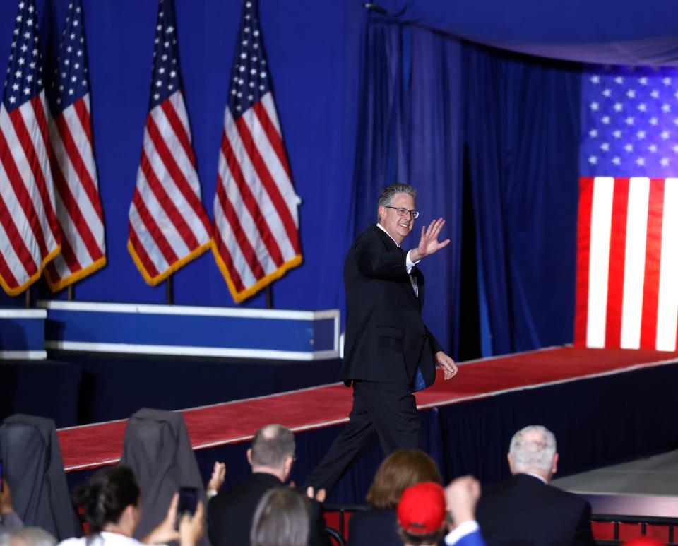 Matthew DePerno, a Republican running for Attorney General, waves to the crowd before her talk to them. Dixon and other politicians took to the stage before former President Donald Trump’s speech at the Macomb Community College, Sports and Expo Center in Warren on Saturday, October 1, 2022.