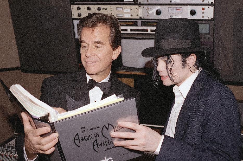 El cantante Michael Jackson y el productor ejecutivo de los Premios American Music Dick Clark revisan el guión durante los ensayos de los premios en el Auditorio Shrine en Los Angeles en una fotografía de archivo del 24 de enero de 1993. Clark, el anfitrión de televisión eternamente jovial y empresario incansable que ayudó a popularizar el rock and roll con el programa "American Bandstand", ha fallecido. Tenía 82 años. (Foto AP/archivo)