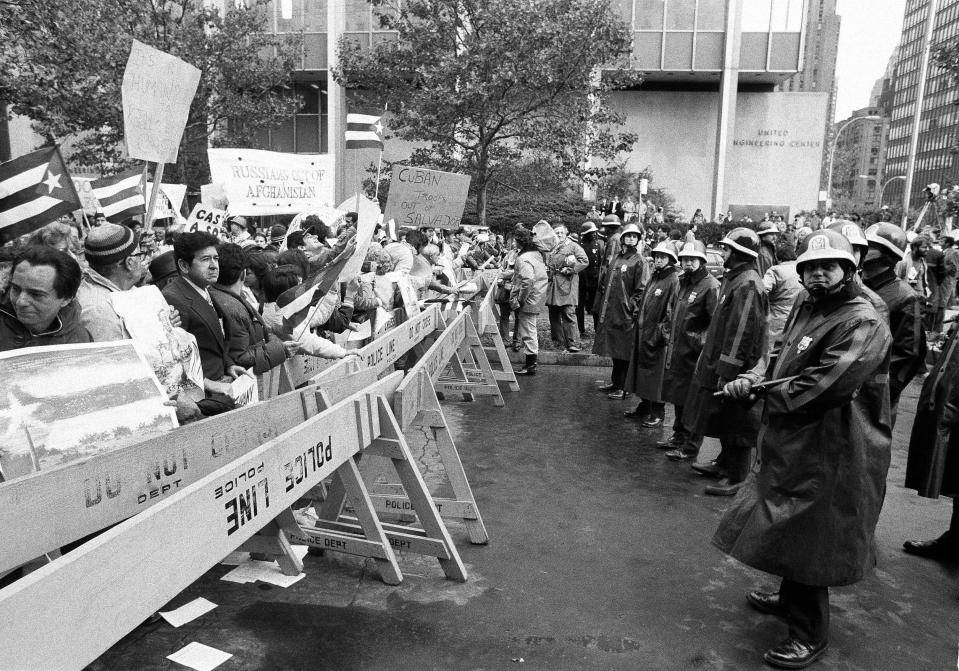 A crowd of anti-Communist demonstrators faces a line of New York City police on Oct. 12, 1979, as they demonstrate outside the United Nations against the visit of Cuban President Fidel Castro. A heavy security force guarded the Cuban leader. (AP Photo/David Karp)