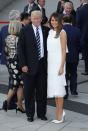 <p>The first lady wore a <a href="http://www.vogue.com/article/melania-trump-michael-kors-christian-louboutin-g20-summit-celebrity-first-lady-style" rel="nofollow noopener" target="_blank" data-ylk="slk:high-necked white flapper-inspired dress by Michael Kors;elm:context_link;itc:0;sec:content-canvas" class="link ">high-necked white flapper-inspired dress by Michael Kors</a> to a concert and dinner for world leaders at the G20 Summit in Hamburg.</p>