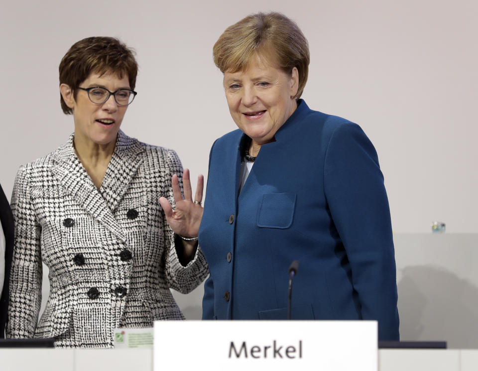 German Chancellor and chairwoman of the German Christian Democratic Union (CDU), Angela Merkel, right, and Annegret Kramp-Karrenbauer, left, General Secretary of the CDU, arrive for a party convention of the CDU in Hamburg, Germany, Friday, Dec. 7, 2018. 1001 delegates are electing a successor of German Chancellor Angela Merkel who doesn't run for party chairmanship after more than 18 years at the helm of the party. (AP Photo/Michael Sohn)