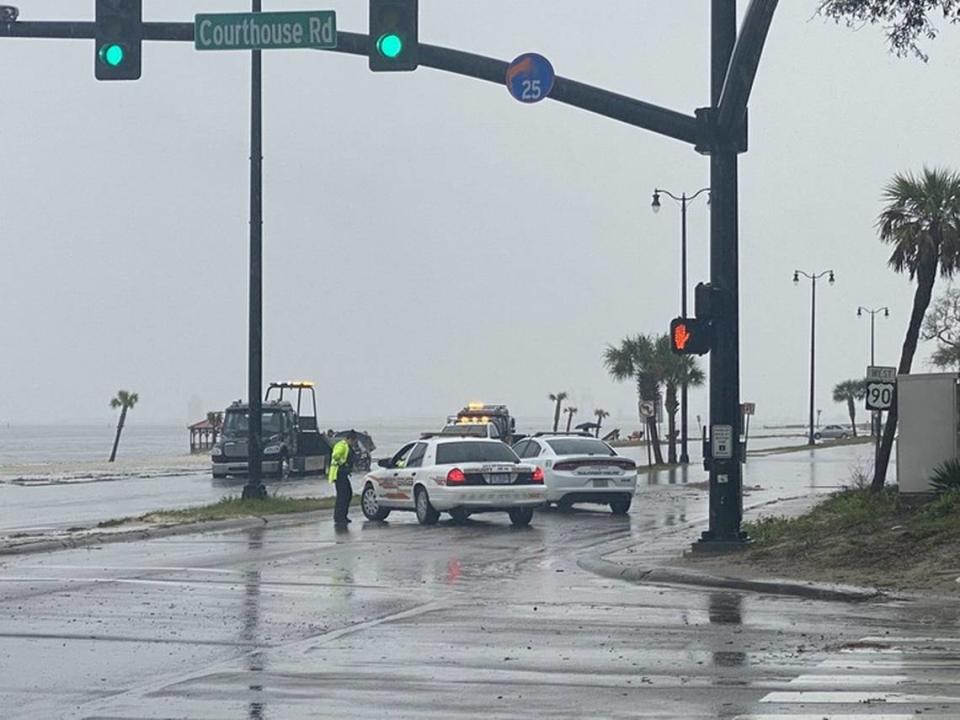 Gulfport police shut down U.S. 90 westbound lanes while a car that flooded is towed. Portions of U.S. 90 were covered in water during severe storms on Wednesday.