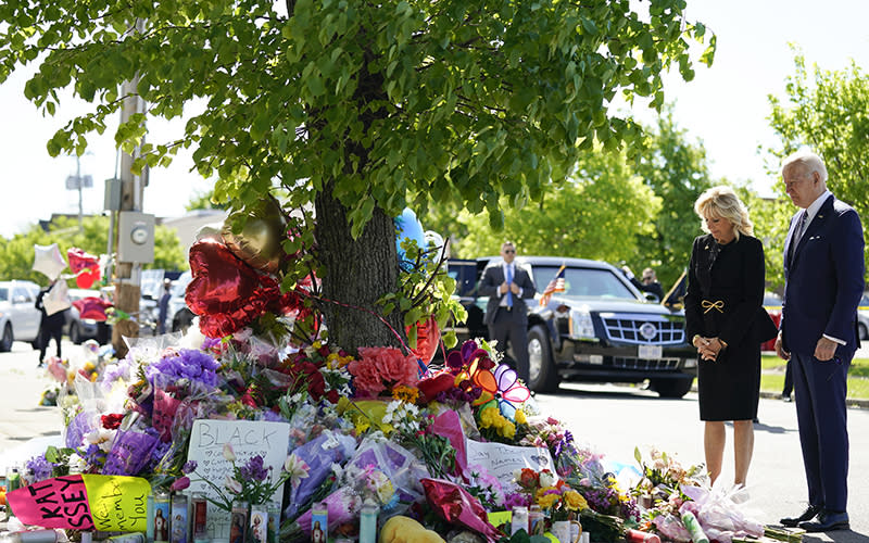 President Biden and first lady Jill Biden visit a memorial with flowers