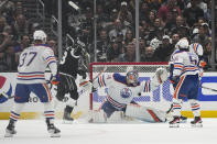 Los Angeles Kings right wing Gabriel Vilardi (13) celebrates after scoring against Edmonton Oilers defenseman Darnell Nurse (25) and goaltender Stuart Skinner (74) during the first period of Game 4 of an NHL hockey Stanley Cup first-round playoff series hockey game Sunday, April 23, 2023, in Los Angeles. (AP Photo/Ashley Landis)