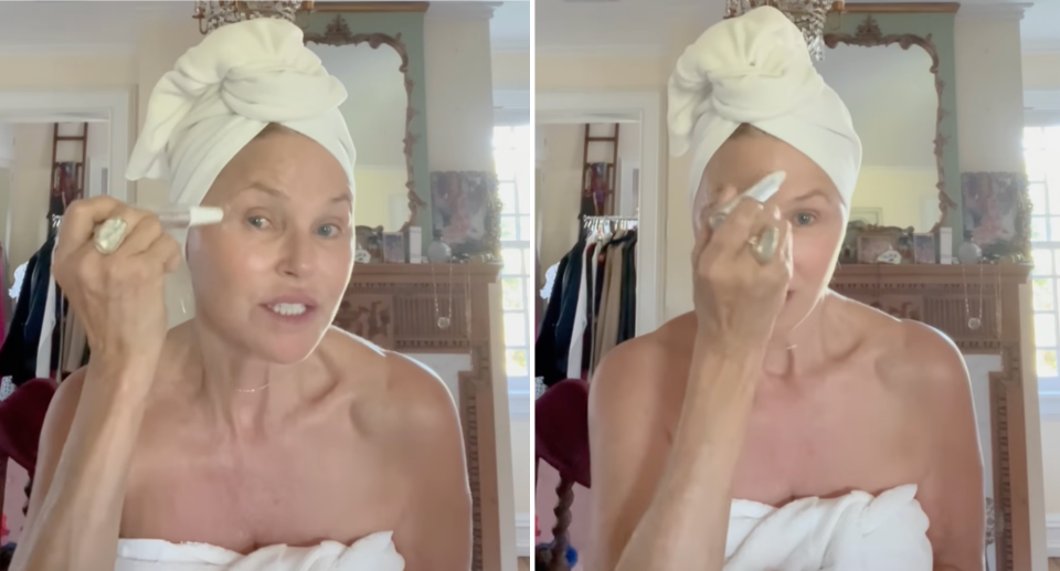 christie brinkley with hair wrapped in white towel wearing white towel around body in home applying sbla beauty The Facial Instant Sculpting Wand