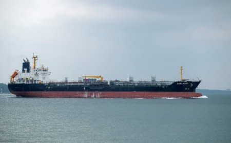 FILE PHOTO: Chemical/Oil Products Tanker Adelaide travels near the shores of Singapore June 10, 2018.  REUTERS/Tim Chong/File Photo