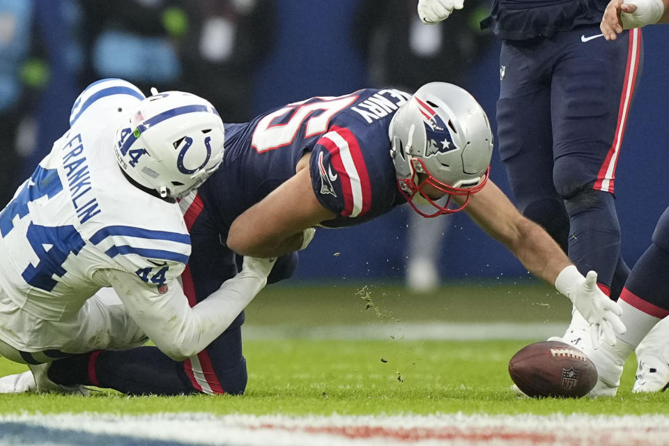 New England Patriots tight end Hunter Henry (85) reaches out in vain to recover his fumble on a pass reception as Indianapolis Colts linebacker Zaire Franklin (44) tackles in the first half of an NFL football game in Frankfurt, Germany Sunday, Nov. 12, 2023. (AP Photo/Martin Meissner)