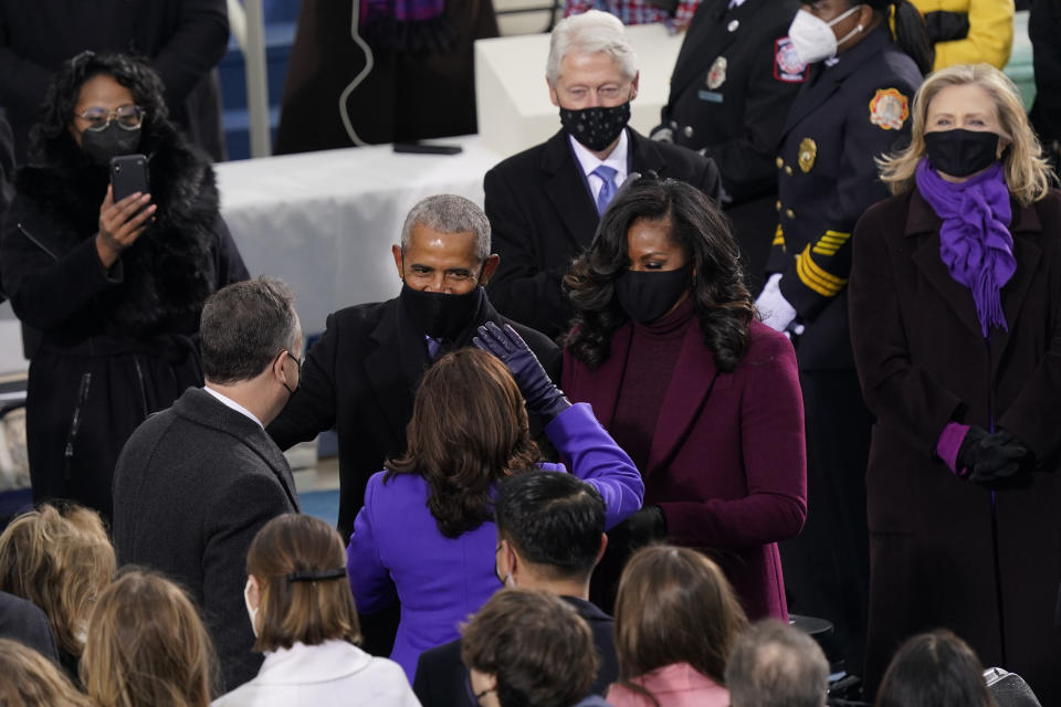 Vice President-elect Kamala Harris and her husband Doug Emhoff talk with former President Barack Obama and his wife Michelle as they arrive for the 59th Presidential Inauguration at the U.S. Capitol in Washington, Wednesday, Jan. 20, 2021. (AP Photo/Carolyn Kaster)