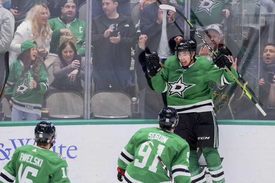 Dallas Stars left wing Jason Robertson, back right, celebrates with teammates Joe Pavelski (16) and Tyler Seguin (91) after scoring a goal in the third period of an NHL hockey game against the Florida Panthers in Dallas, Sunday, Jan. 8, 2023. (AP Photo/Gareth Patterson)