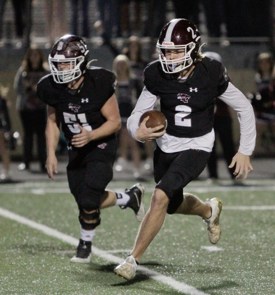 Quarterback Rodey Hooper (right) scrambles as Corley Williams blocks against Marlin on Dec. 9.