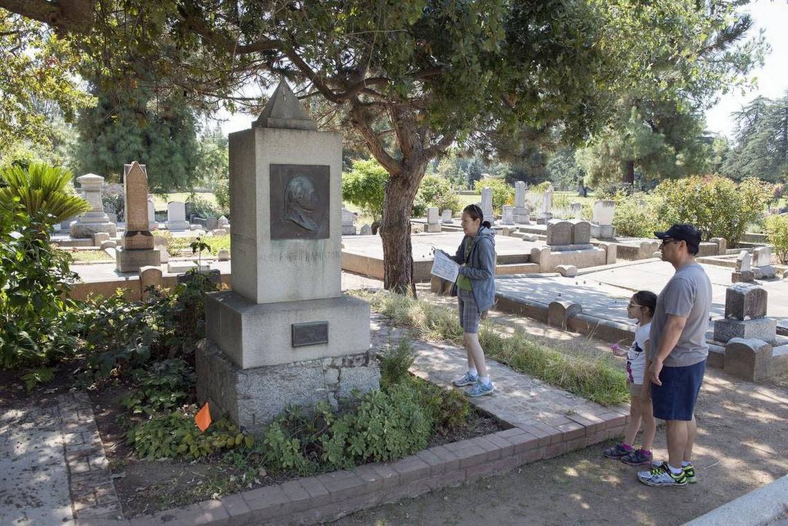 The Melendrez family from West Covina – Erin, 8, with her parents Carmen and Martin – look at the grave of William Stephen Hamilton at the Sacramento Historic City Cemetery in 2016. Hamilton is the son of America’s first treasury secretary, the subject of the hit musical “Hamilton.” Randy Pench/Sacramento Bee file