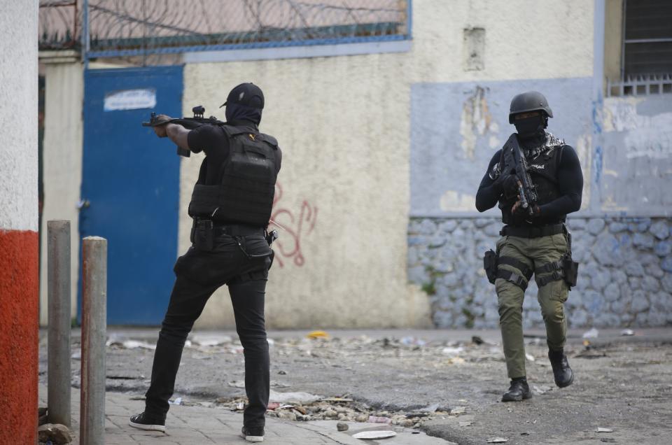 National police officers patrol during a demonstration demanding the resignation of Prime Minister Ariel Henry, in Port-au-Prince, Haiti, Wednesday, Feb. 7, 2024. (AP Photo/Odelyn Joseph)