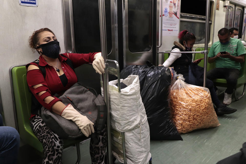 A woman with merchandise on board the Mexico City subway during a health emergency, orange traffic light by COVID-19 and epidemiological alert to return to red due to an increase in coronavirus cases in the capital. (Photo by Gerardo Vieyra/NurPhoto via Getty Images)