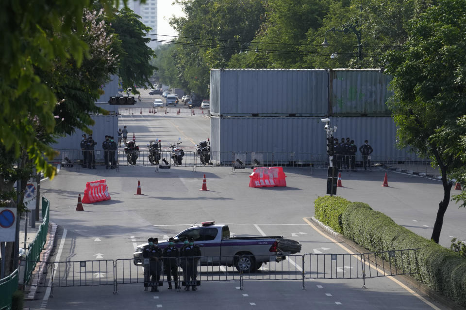 Police are deployed to block any approach to Government House with shipping containers in Bangkok, Thailand, Tuesday, Aug. 23, 2022. Thailand’s Constitutional Court on Monday received a petition from opposition lawmakers seeking a ruling on whether Prime Minister Prayuth Chan-ocha has reached the legal limit on how long he can remain in office. (AP Photo/Sakchai Lalit)
