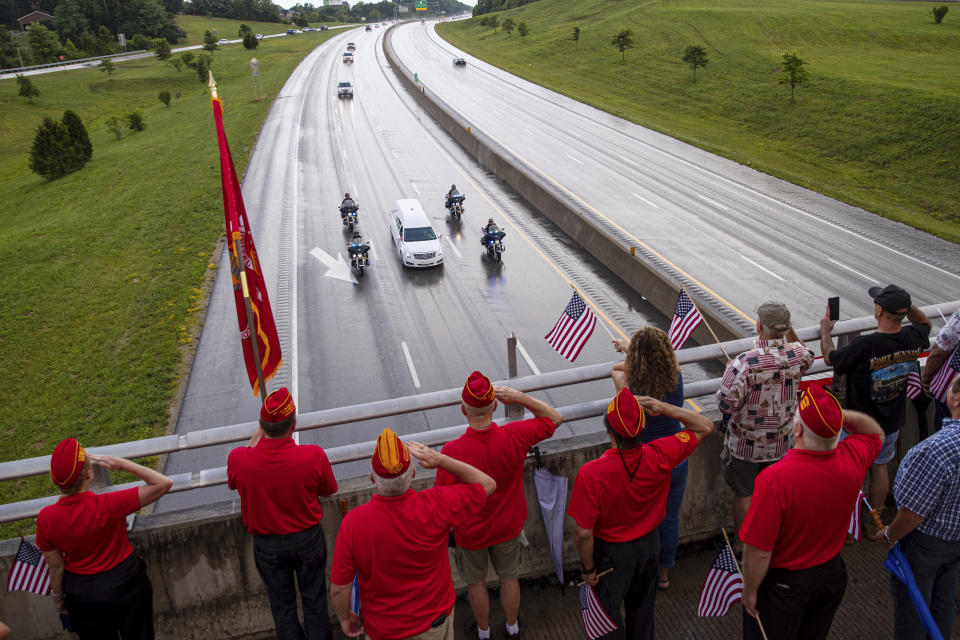 Marine Corps League veterans salute as the funeral procession for Medal of Honor recipient Hershel "Woody" Williams moves along Interstate 64 on Saturday, July 2, 2022, in Teays Valley, W.Va. (Sholten Singer/The Herald-Dispatch via AP)