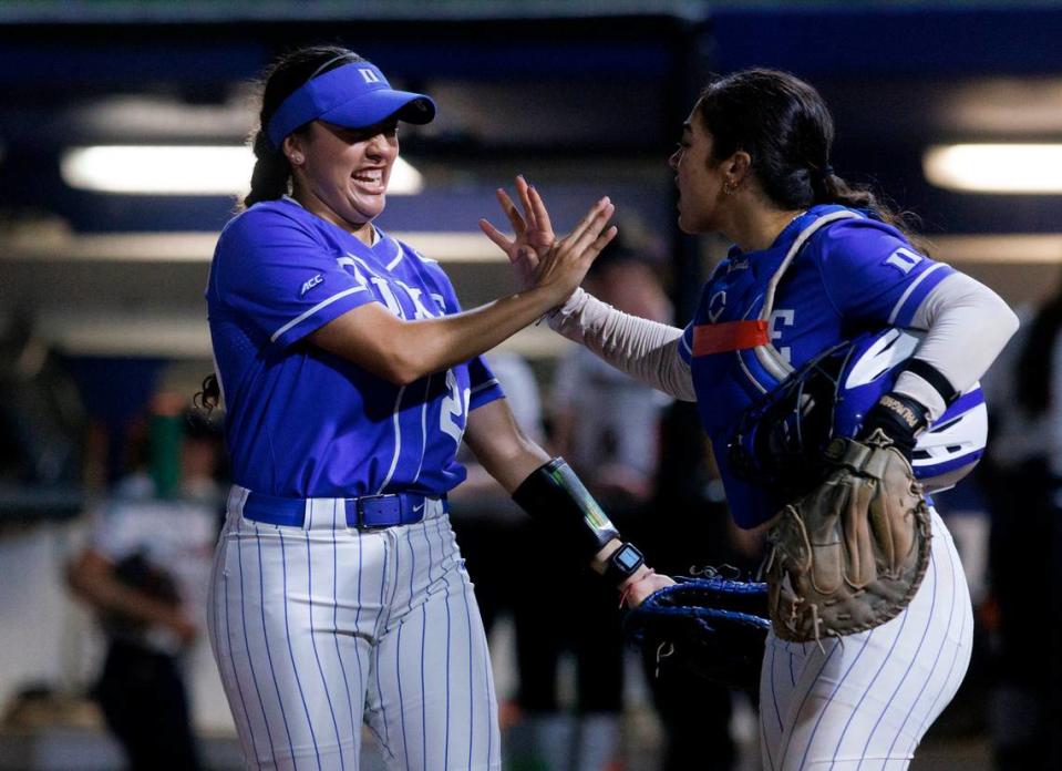 Duke’s Gisele Tapia and Kelly Torres high-five during the eighth inning of the Blue Devils’ 1-0 win over Virginia on Friday, April 19, 2024, in Durham, N.C.