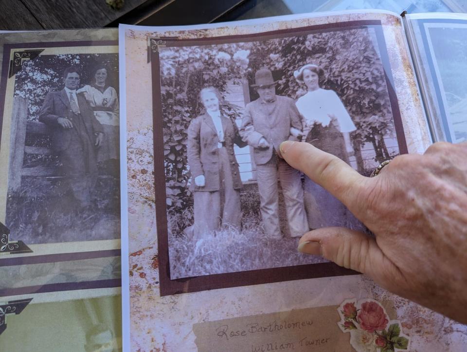 Lavonne Parker showing a photo of William Towner, the original hop farmer and the original owner of the property with nieces Mrs. Lambert on the right, and Miss Bartholomew on the left.