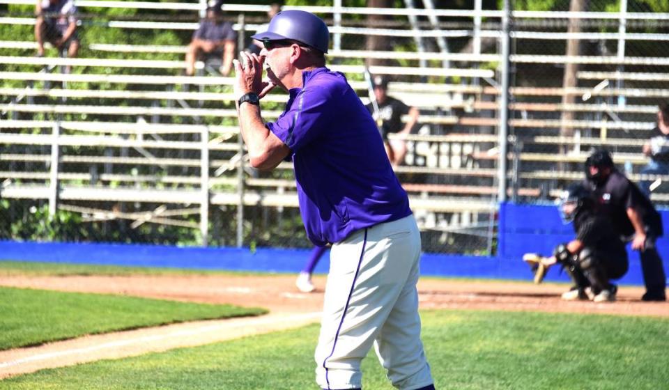 Livingston High baseball coach Matt Winton yells out instructions to a baserunner while coaching third base during a game against Enochs on Tuesday, April 2, 2024 at Atwater’s Memorial Ballpark.