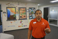 Malik Stewart, director of multicultural student services at the College of Saint Benedict and Saint John's University, is seen in the hall of the multicultural building on the college's campus in St. Joseph, Minn., on Tuesday, Nov. 8, 2022. The building houses the two Catholic schools' LGBTQ student organization, QPLUS, which they fund as part of their effort to be more affirming of this student population. (AP Photo/Giovanna Dell'Orto)