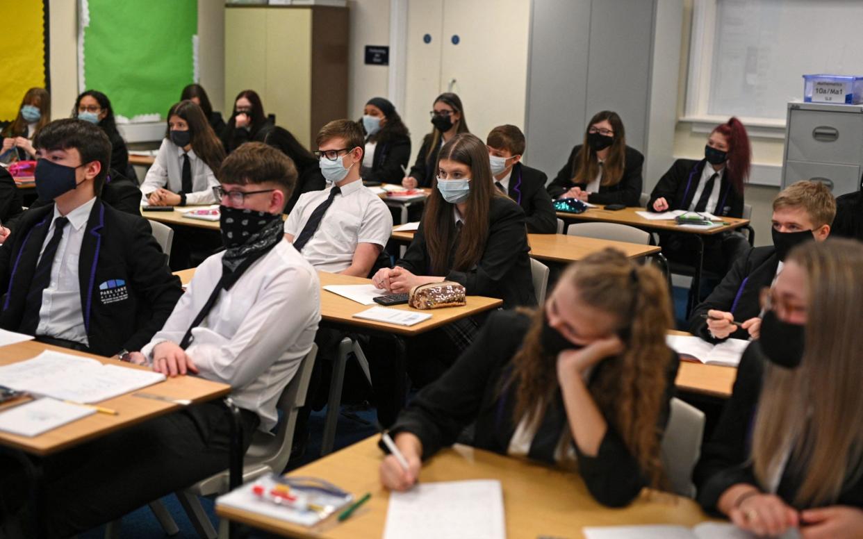 Year 11 students, wearing face coverings, take part in a GCSE maths class at Park Lane Academy in Halifax, northwest England on March 8, 2021 as schools reopen following the easing of lockdown restrictions - OLI SCARFF /AFP