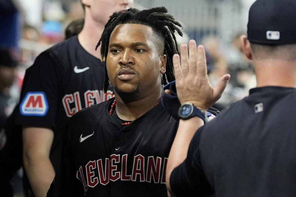 Cleveland Guardians' Jose Ramirez is congratulated after scoring on a single hit by David Fry during the sixth inning of a baseball game against the Miami Marlins, Sunday, June 9, 2024, in Miami. (AP Photo/Lynne Sladky)