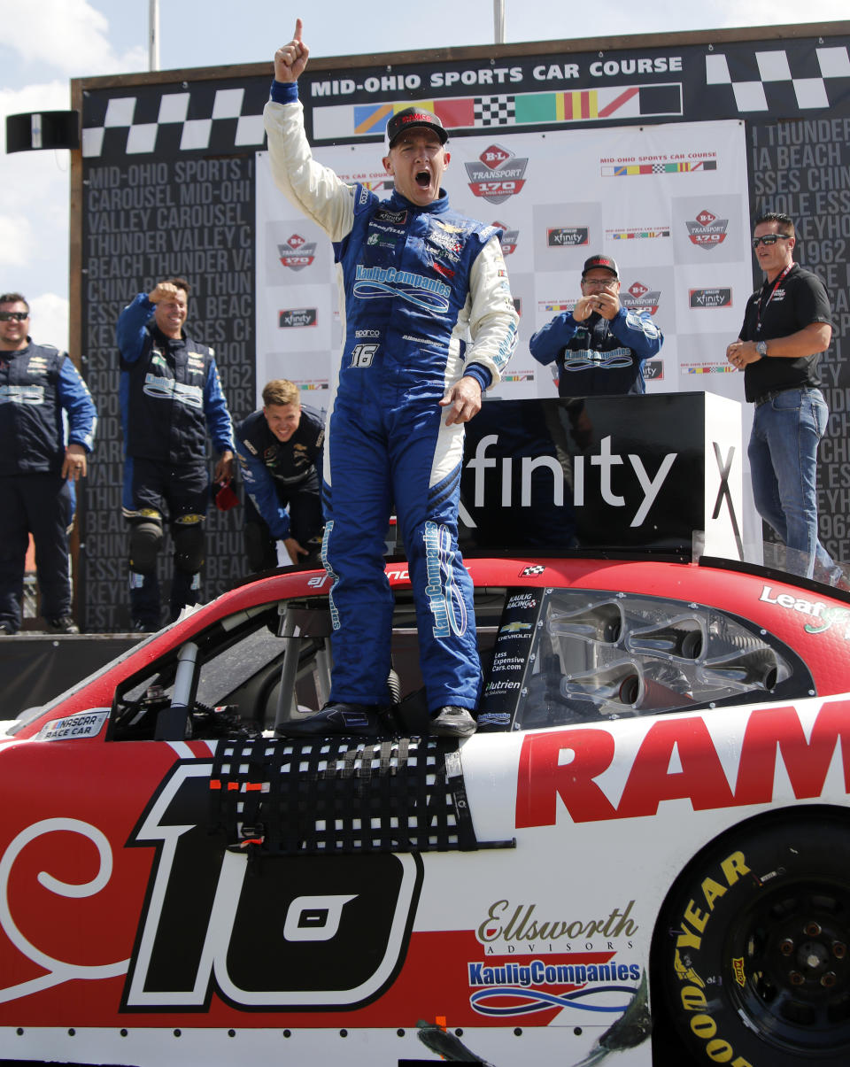 A.J. Allmendinger celebrates in Victory Lane after winning the B&L Transport 170 NASCAR Xfinity Series auto race at Mid-Ohio Sports Car Course on Saturday, June 5, 2021, in Lexington, Ohio. (AP Photo/Tom E. Puskar)