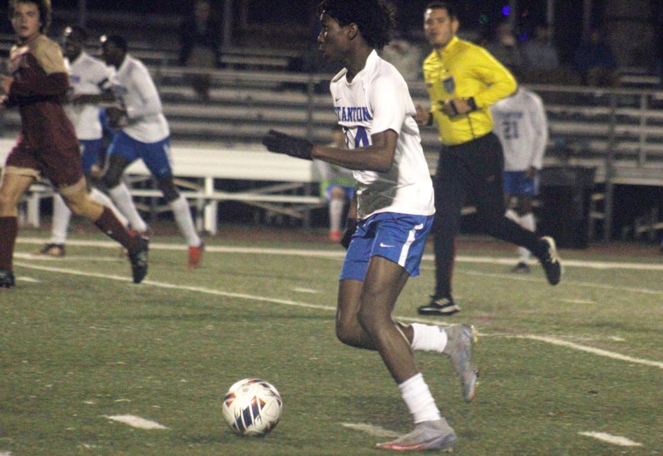 Stanton midfielder Leonard Spears (14) dribbles up the field against Episcopal during a Dec. 21 game.
