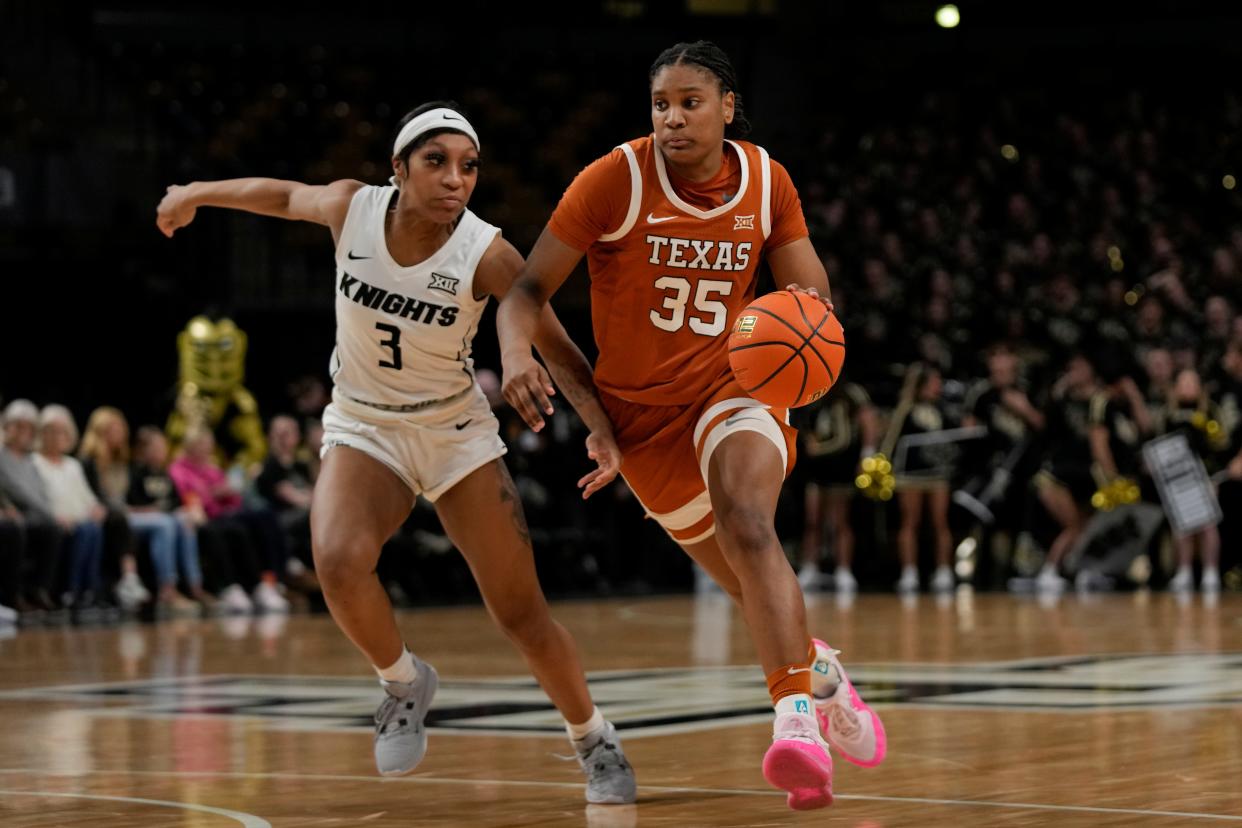 Texas forward Madison Booker (35) drives past Central Florida guard Kaitlin Peterson (3) during the second half of an NCAA college basketball game, Saturday, Feb. 24, 2024, in Orlando, Fla. (AP Photo/John Raoux)