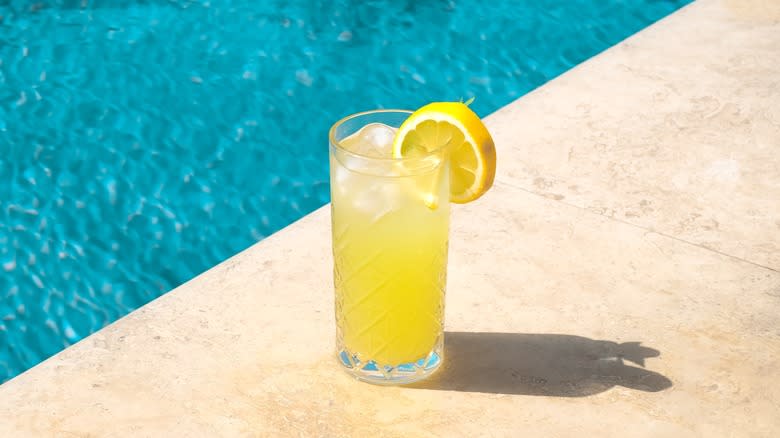 Glass of lemonade by the pool