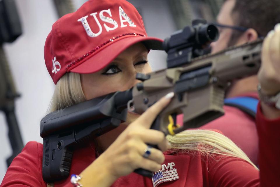 Keleigh Glover looks over a rifle scope in the Vortex booth at the 148th NRA Annual Meetings & Exhibits on April 27, 2019 in Indianapolis, Indiana.