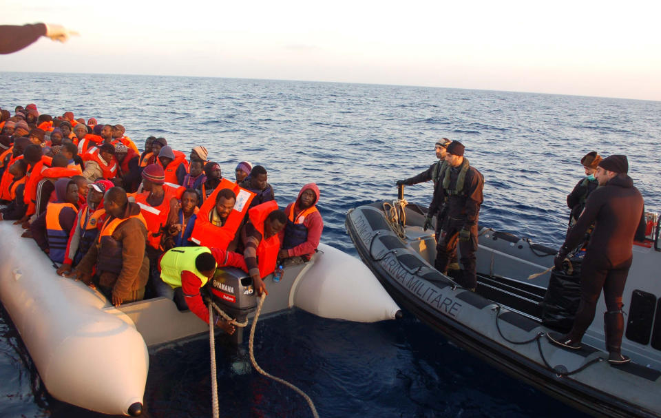 In this photo released by the Italian Navy Thursday, March 20, 2014, migrants stand on a dinghy after being rescued along the Mediterranean sea. Italian authorities say they have rescued more than 4,000 would-be migrants at sea over the past four days as the war in Syria and instability in Libya spawn new waves of refugees. The numbers of migrants reaching Italian shores generally rises as warm weather and calm seas make the Mediterranean Sea crossing from North Africa easier. But the U.N. refugee agency says the 2014 numbers represent a 300 percent increase over the same period in 2013. (AP Photo/Italian Navy)