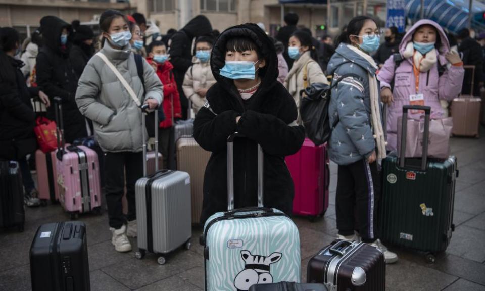 Travellers at Beijing railway station on Wednesday