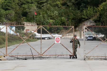 Albanian Armed Forces member closes the gate in Kucova Air Base in Kucova, Albania, October 3, 2018. REUTERS/Florion Goga