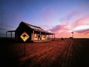 <p>A man stands on the porch of a New South Wales hotel during sunset. </p>